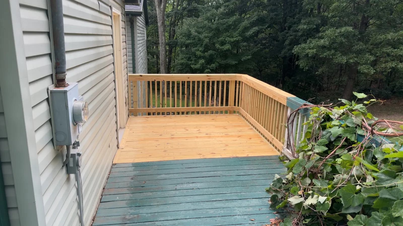 Rebuilt porch deck and new railings on an older home