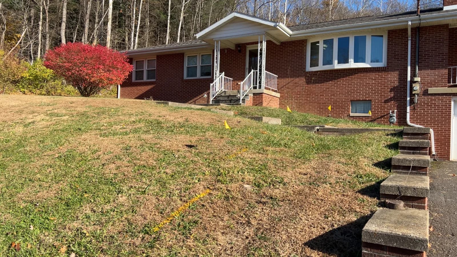 White aluminum porch railings on a brick ranch home
