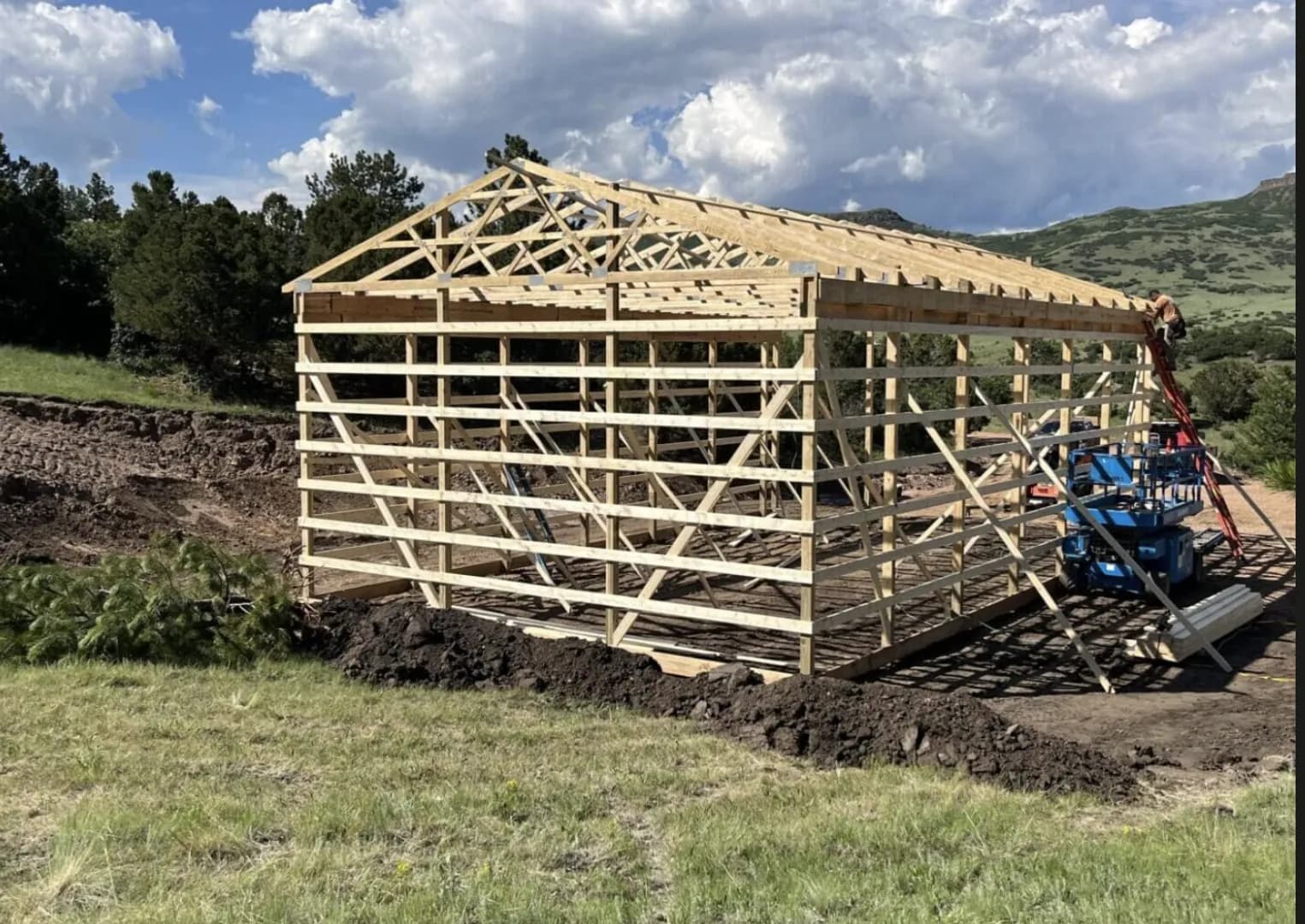 Post-frame pole barn with trusses and purlins set during construction
